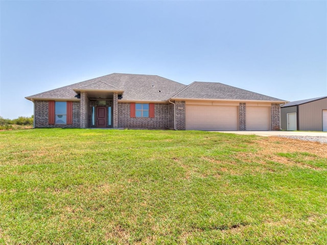 view of front of home featuring a garage and a front lawn