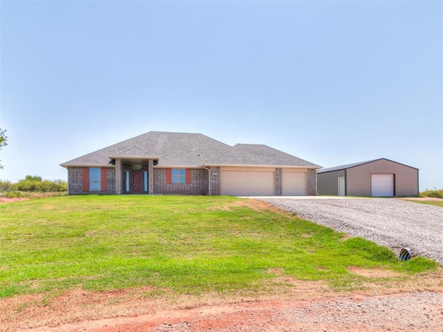 view of front facade with an outbuilding, a front yard, and a garage