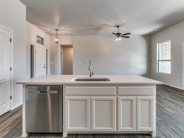 kitchen with pendant lighting, a center island with sink, sink, stainless steel dishwasher, and white cabinetry