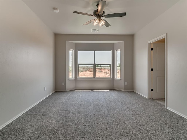 spare room featuring ceiling fan and light colored carpet