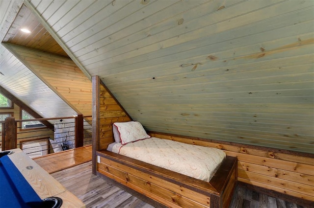 bedroom featuring wood walls, hardwood / wood-style floors, wood ceiling, and vaulted ceiling