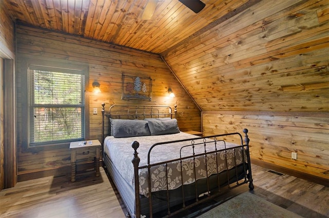 bedroom featuring hardwood / wood-style flooring, wood walls, lofted ceiling, and wood ceiling