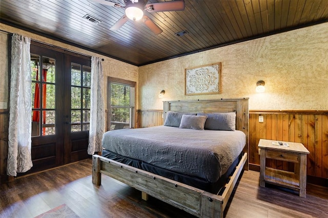 bedroom featuring hardwood / wood-style flooring, ceiling fan, wood walls, and wooden ceiling