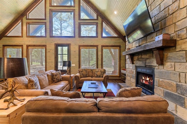 living room featuring wood walls, high vaulted ceiling, hardwood / wood-style flooring, a fireplace, and wood ceiling