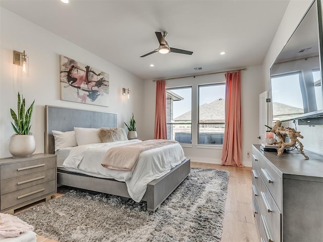 bedroom featuring light hardwood / wood-style flooring and ceiling fan