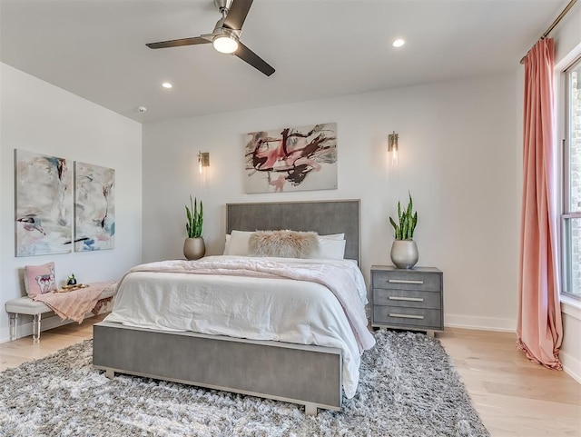 bedroom with ceiling fan and light hardwood / wood-style flooring