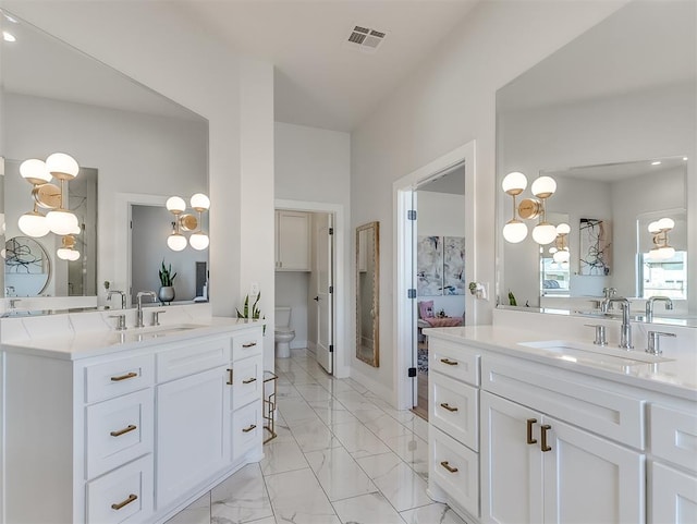 bathroom featuring vanity and toilet