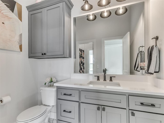 bathroom with tile patterned flooring, vanity, and toilet