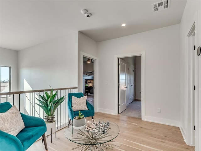 sitting room featuring ceiling fan and light hardwood / wood-style flooring