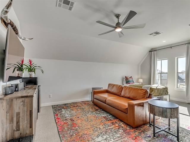 carpeted living room with vaulted ceiling and ceiling fan