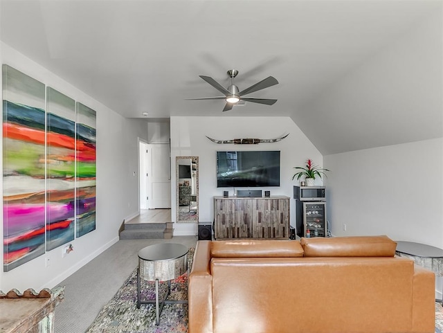 carpeted living room with ceiling fan and lofted ceiling