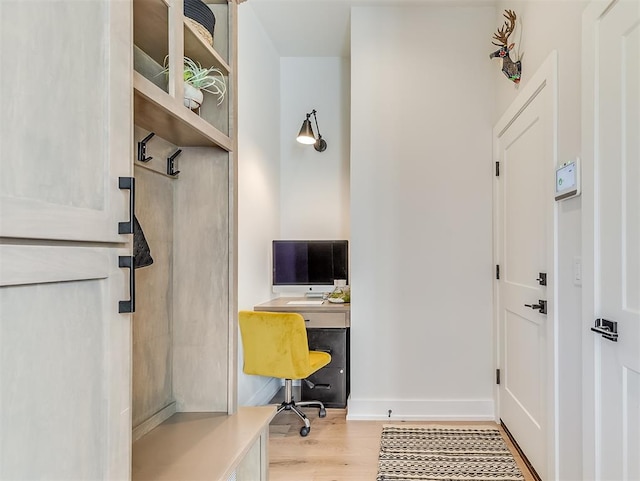 office featuring built in desk and light hardwood / wood-style flooring