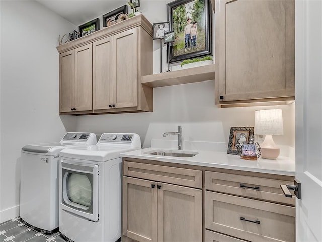 laundry room featuring cabinets, washer and dryer, and sink