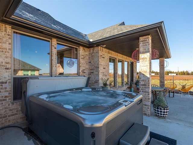 view of patio / terrace with a hot tub