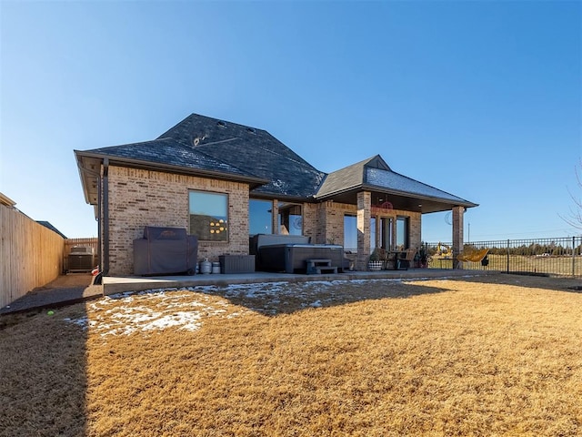 back of property featuring a yard and a patio area