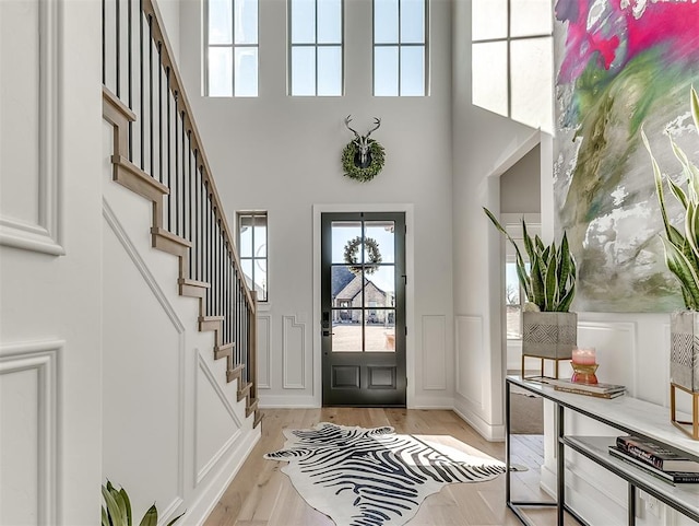 foyer with a high ceiling and light wood-type flooring