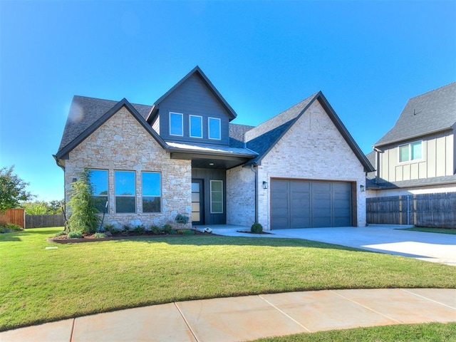 view of front of home featuring a front yard and a garage