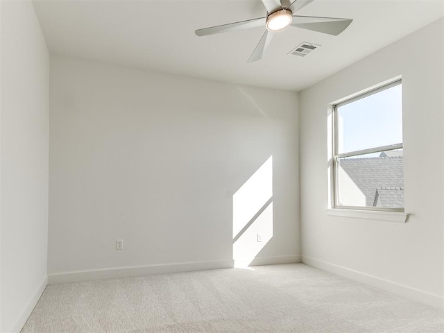 carpeted spare room featuring ceiling fan