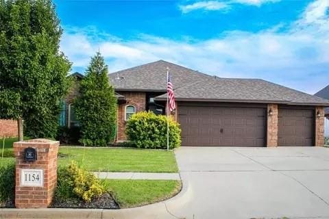 ranch-style home featuring a front yard and a garage