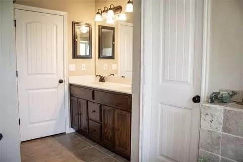 bathroom with tile patterned flooring and vanity