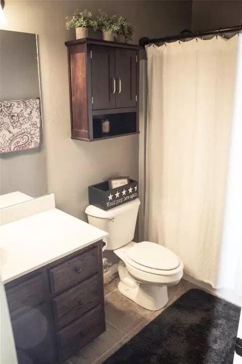 bathroom featuring tile patterned floors, vanity, and toilet