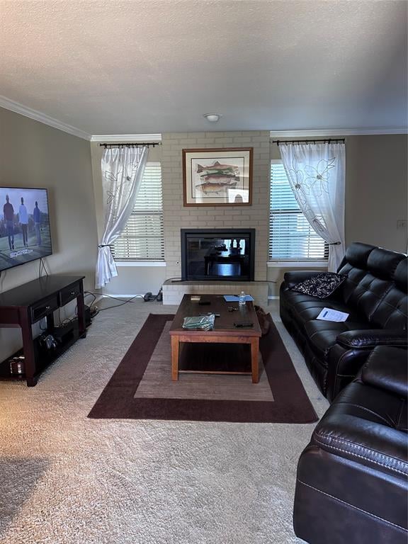 carpeted living room with crown molding, a textured ceiling, a wealth of natural light, and a brick fireplace