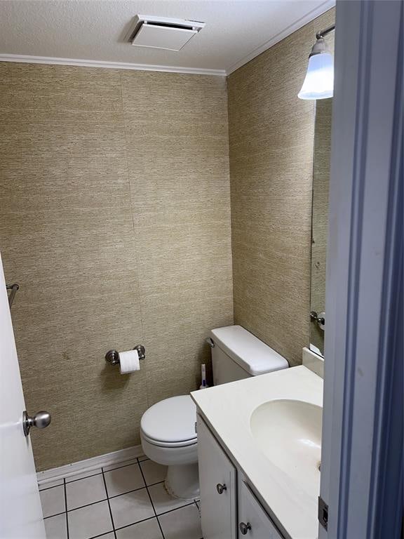 bathroom with toilet, tile patterned flooring, vanity, and ornamental molding