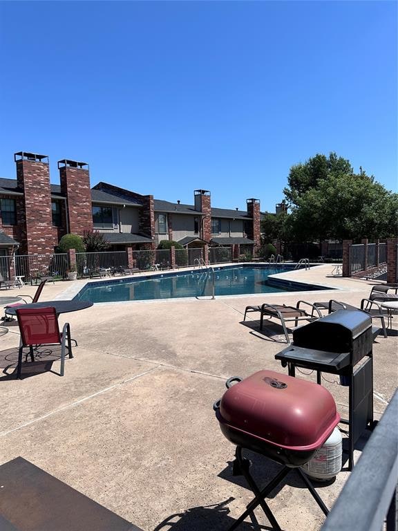 view of swimming pool with a patio area and grilling area