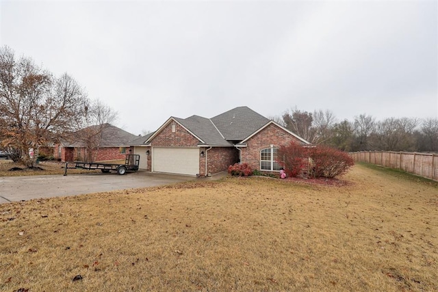 view of front of property featuring a front yard and a garage