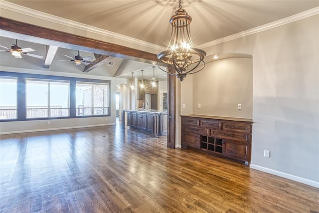 unfurnished living room featuring dark wood-style flooring, arched walkways, a sink, baseboards, and ceiling fan with notable chandelier