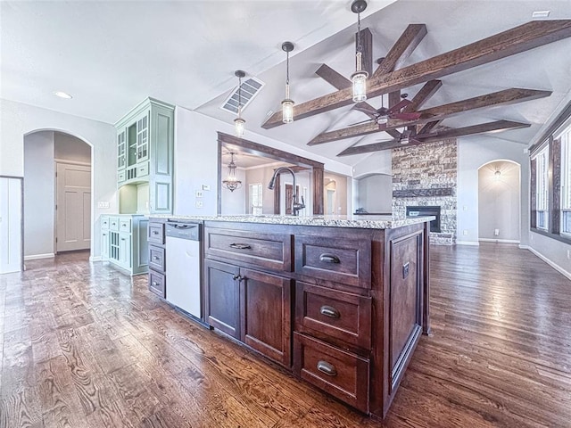 kitchen with arched walkways, ceiling fan, lofted ceiling with beams, and dishwashing machine