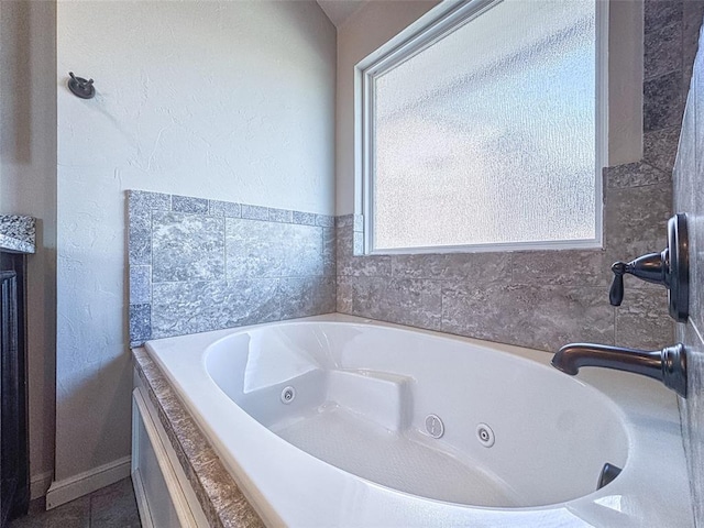 full bathroom featuring a tub with jets