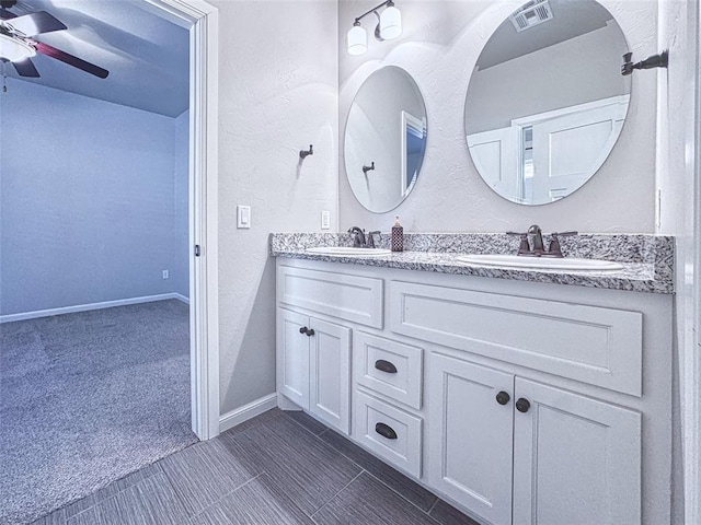 full bath featuring visible vents, a sink, a ceiling fan, and double vanity