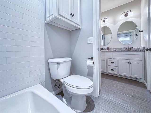 full bath featuring vanity, tile patterned flooring, and toilet