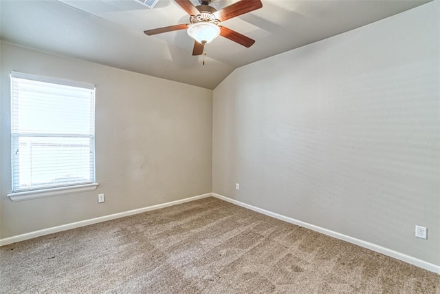 empty room featuring baseboards, carpet, and lofted ceiling