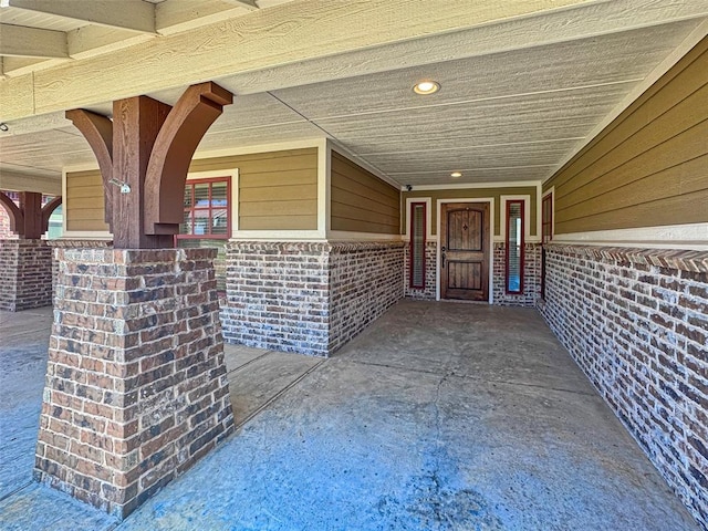 doorway to property featuring brick siding