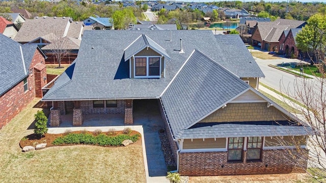birds eye view of property featuring a water view and a residential view