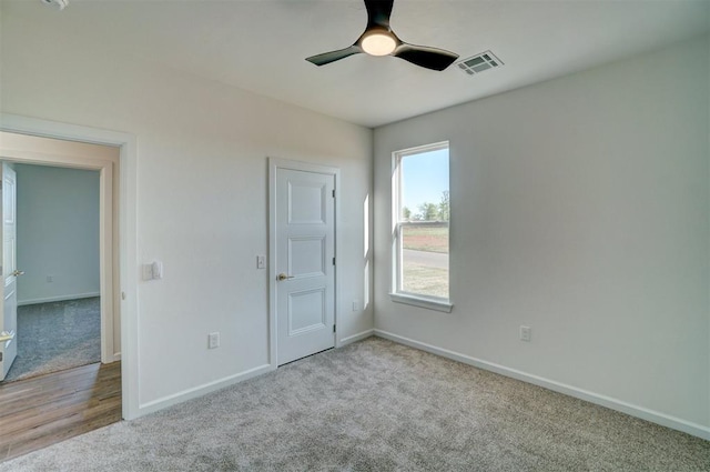 carpeted empty room with ceiling fan