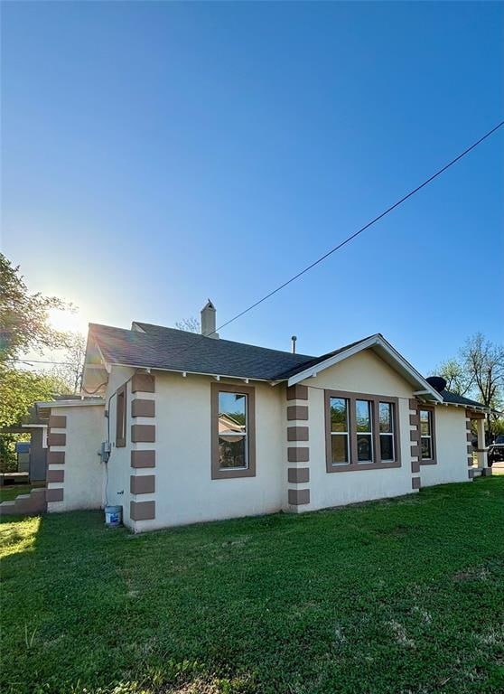 back of house with a lawn