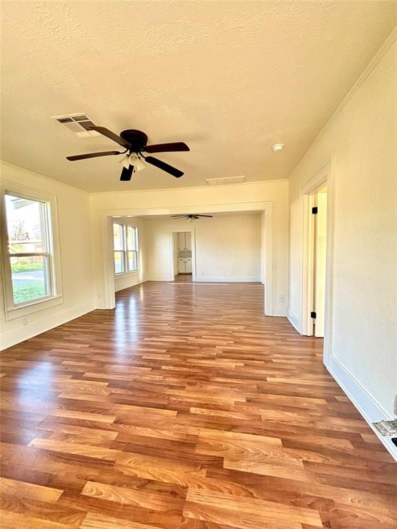 spare room with a textured ceiling, light hardwood / wood-style flooring, and ceiling fan