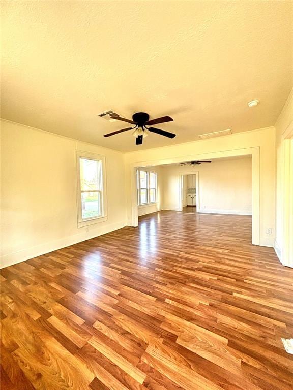 empty room featuring ceiling fan, light hardwood / wood-style floors, and a textured ceiling