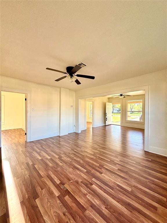 empty room featuring ceiling fan, wood-type flooring, and a textured ceiling