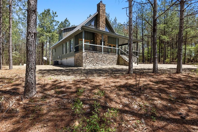 view of side of home with central air condition unit and covered porch