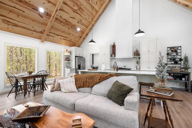 living room with wood ceiling, high vaulted ceiling, sink, and light hardwood / wood-style flooring