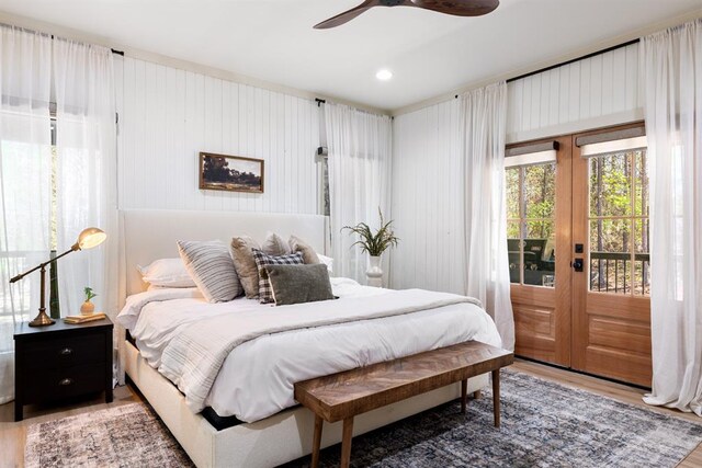 bedroom featuring hardwood / wood-style flooring, access to exterior, ceiling fan, and french doors