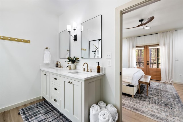 bathroom featuring wood-type flooring, vanity, and french doors