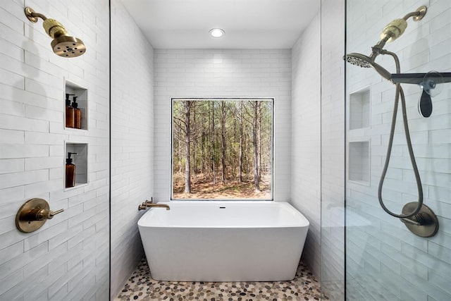 bathroom featuring independent shower and bath and tile walls