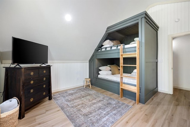 bedroom with lofted ceiling and light hardwood / wood-style floors