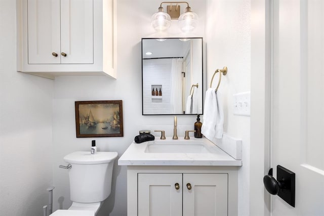 bathroom featuring vanity and toilet