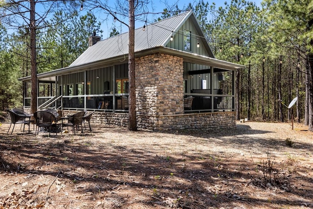 view of property exterior with a sunroom